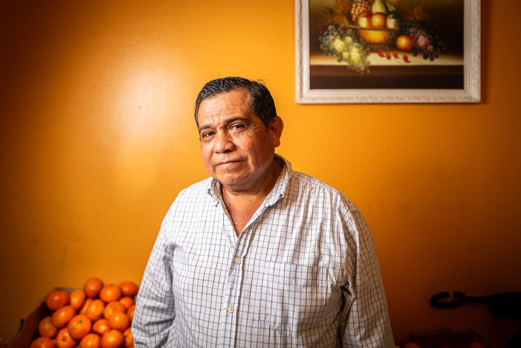A subject photographed against a warm orange wall — real footage anchoring a studio's archive