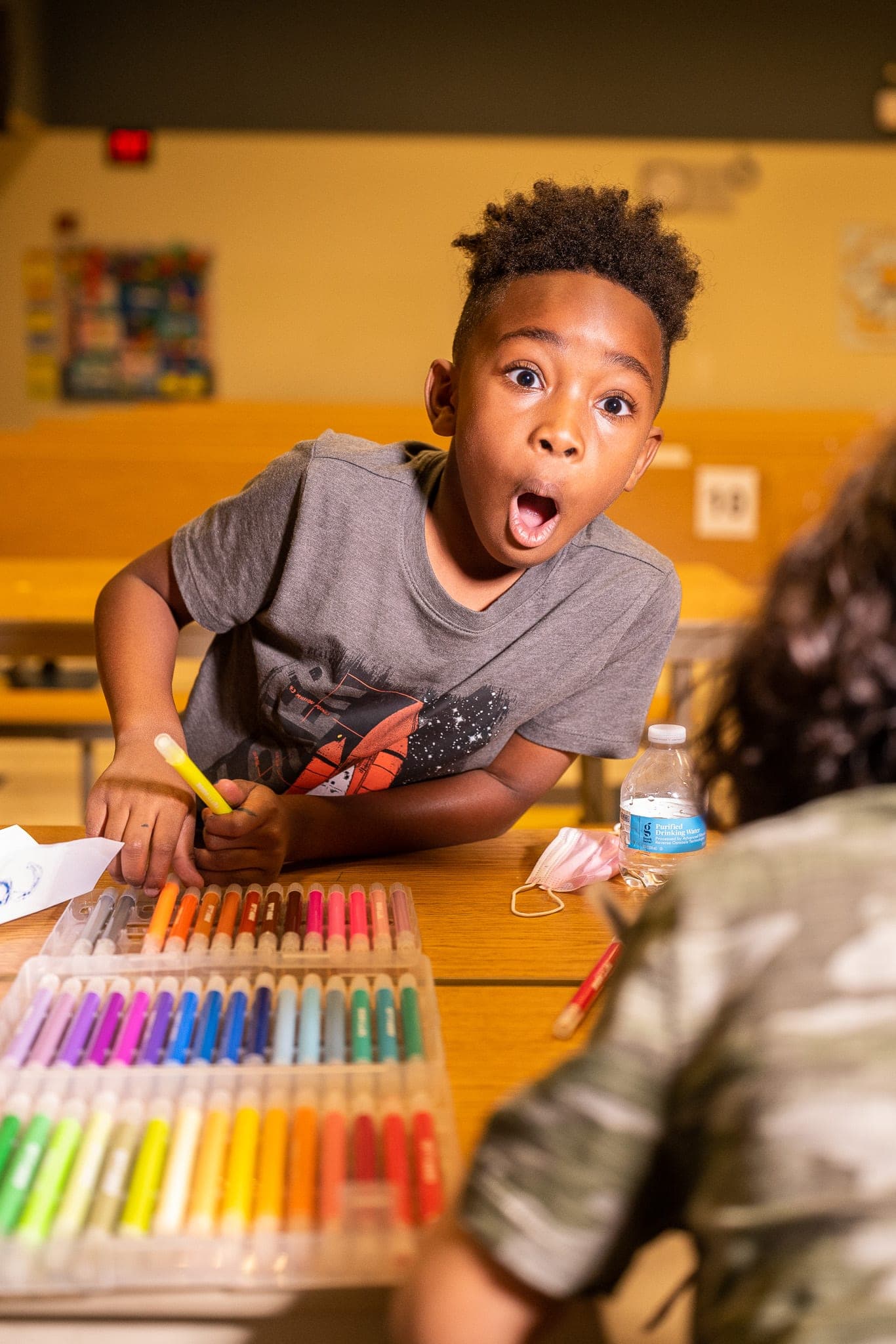A child mid-laugh outdoors — the kind of candid program moment that becomes a clip, a poster, and a donor story
